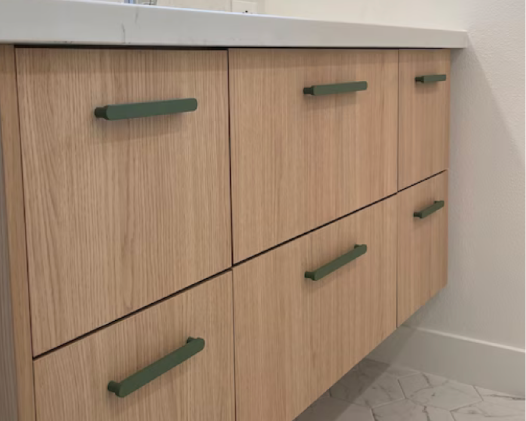 Wooden drawers with Olive Green Cabinet Handles, adding a modern and stylish touch to a bathroom vanity.
