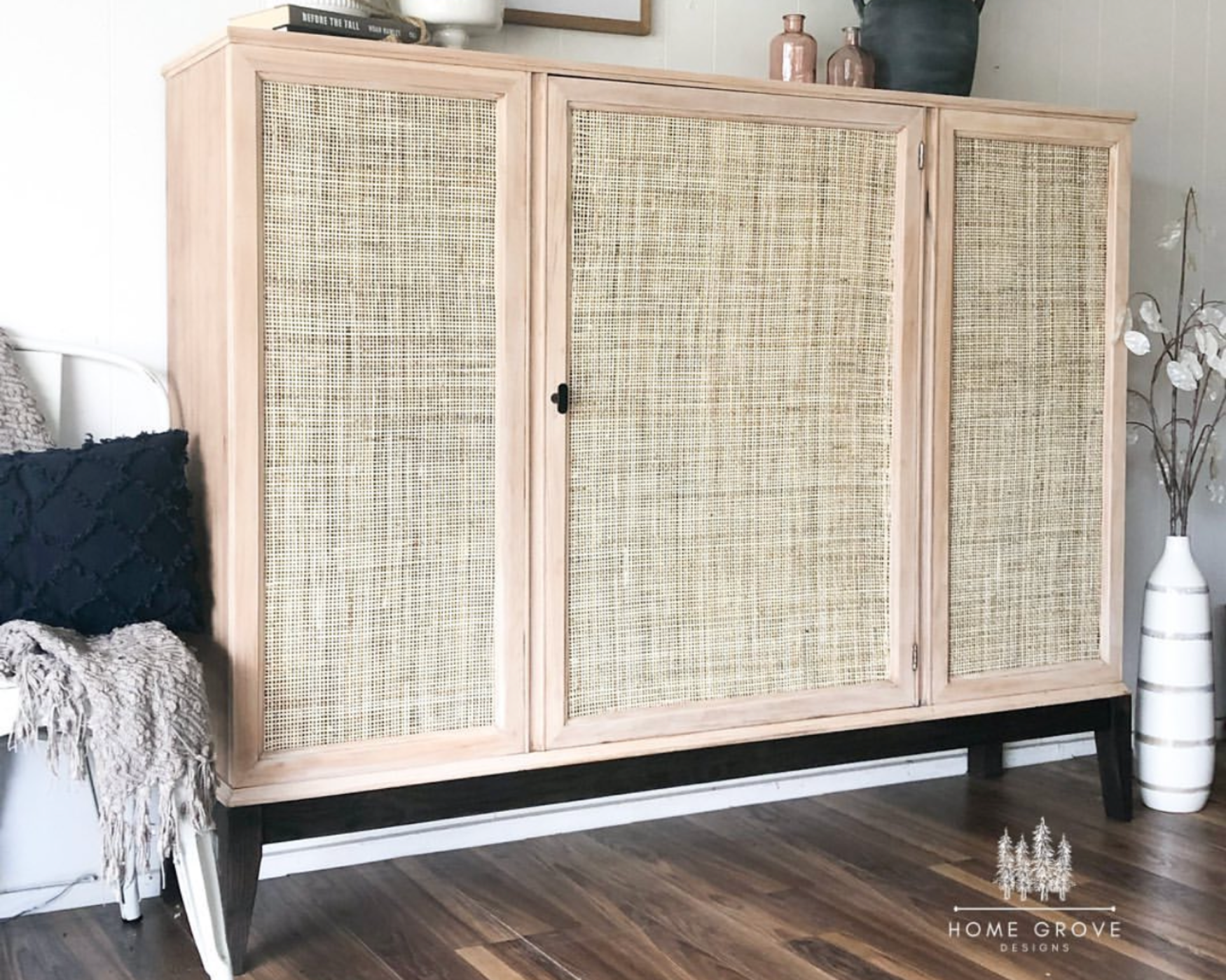 Mid-century modern cabinet with rattan doors and a black knob, styled for creative home renovation with ROUS hardware.