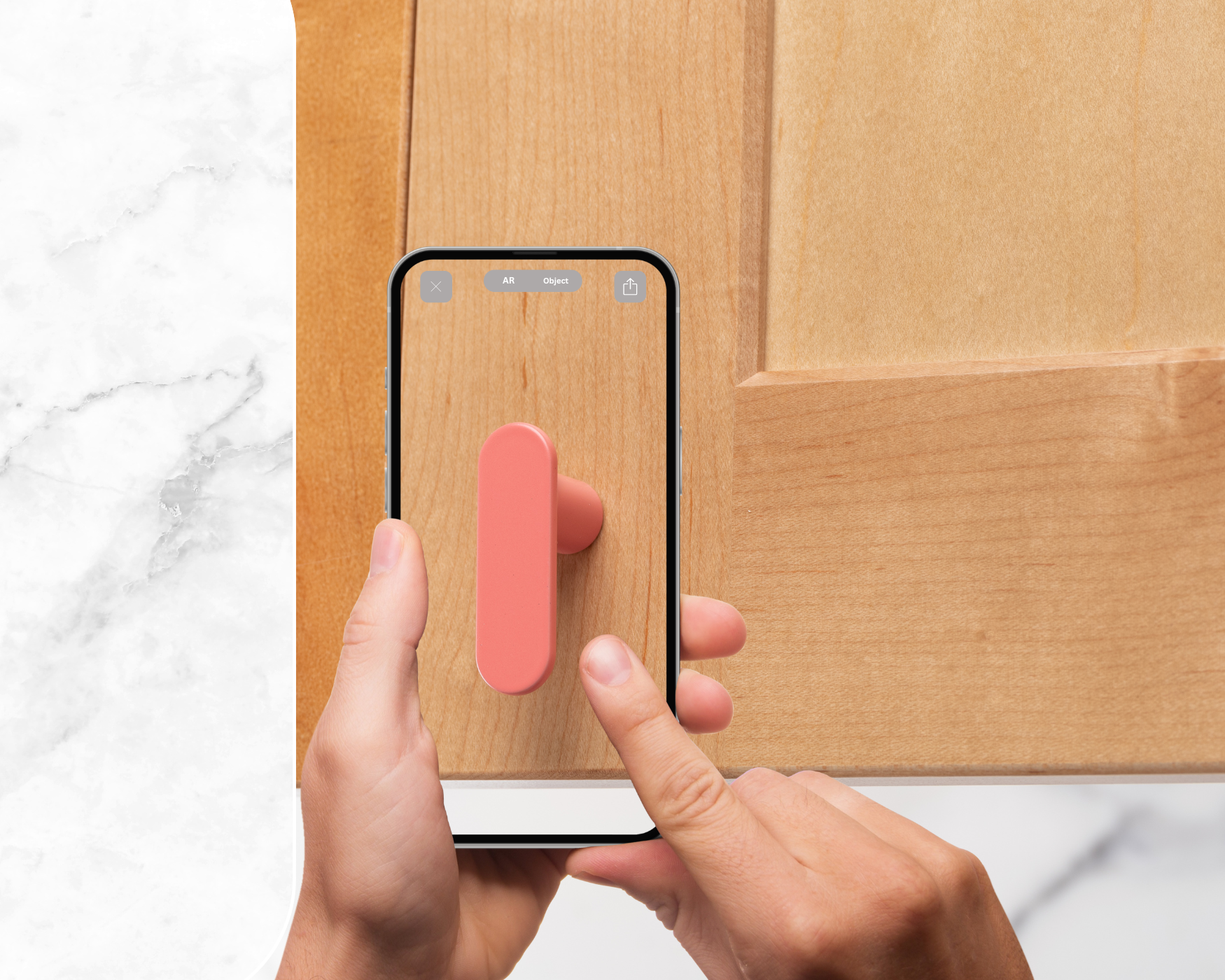 A person using a smartphone to view a kitchen knob design via augmented reality, visualizing it in their real home space.