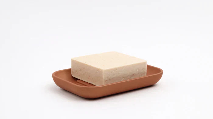 Minimalist brown soap dish from Rous Hardware holding a rectangular  bar soap, ideal for organized and mess-free shower spaces