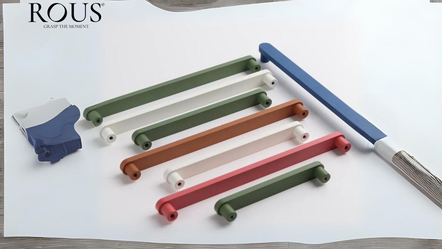 Assorted mid century modern kitchen cabinet handles in bold colors, showcased with a modern paint palette and design tools.
